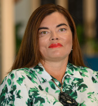 Photo of Ronelle - a woman with long brown hair wearing a green and white shirt